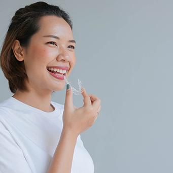 Patient holding clear aligner